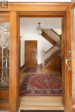 Hamilton (Blakeley) apartment for rent - A wooden door with a glass window and a rug in front of it.