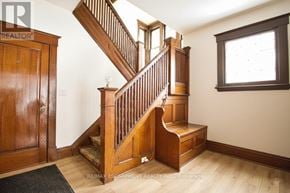 Hamilton (Blakeley) apartment for rent - A wooden staircase with a carpeted runner leads up to a landing with a window.