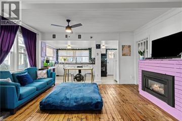 Crystal Beach apartment for rent - A living room with a blue couch and a pink fireplace.