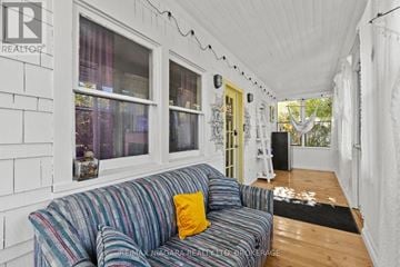 Fort Erie (Crystal Beach) apartment for rent - A living room with a striped couch and a white ceiling.