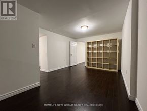 Toronto (L'amoreaux) apartment for rent - A room with a wooden floor and a built-in bookshelf.