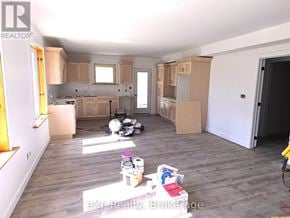 South Bruce duplex for rent - A room with wooden floors and white walls is under renovation.