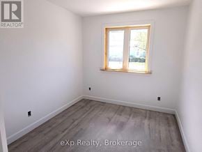 South Bruce duplex for rent - A room with a window and wooden flooring.