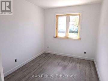 South Bruce multi-family for rent - A room with a window and wooden flooring.