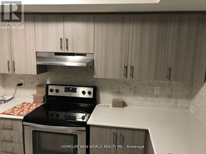 Oshawa (Windfields) townhouse for rent - A kitchen with a stove top oven and microwave.
