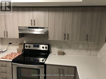 Oshawa (Windfields) townhouse for rent - A kitchen with a stove top oven and microwave.