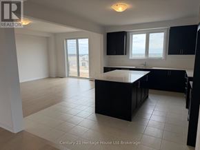 South-West Oxford apartment for rent - A kitchen with black cabinets and a large island in the middle.