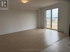 South-West Oxford apartment for rent - Empty room with a sliding glass door leading to a construction site.