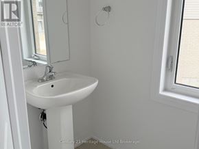 South-West Oxford apartment for rent - A white sink in a bathroom with a window.