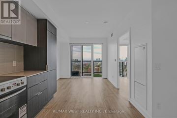 Toronto (Cabbagetown-South St. James Town) condo for rent - A modern kitchen with dark wood cabinets and a stove top oven.