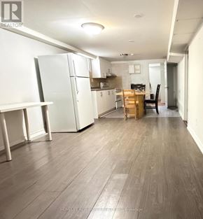 Toronto (Hillcrest Village) apartment for rent - A kitchen with white appliances and wood flooring.