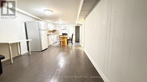 Toronto (Hillcrest Village) apartment for rent - A spacious kitchen with white cabinets and a refrigerator.