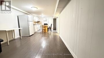 Toronto (Hillcrest Village) apartment for rent - A spacious kitchen with white cabinets and a refrigerator.