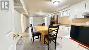 Toronto (Hillcrest Village) apartment for rent - A kitchen with a table and chairs in the middle of the room.