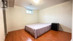 Toronto (Hillcrest Village) apartment for rent - A bedroom with a bed, a window, and a black speaker.