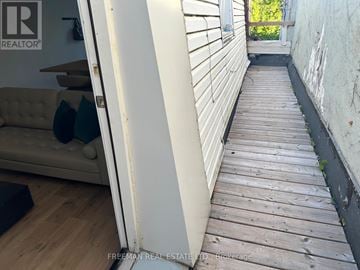 Toronto (Lawrence Park North) townhouse for rent - A wooden deck leads to a balcony outside a house.