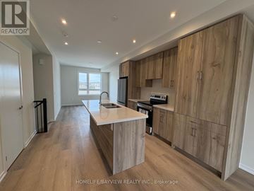 Richmond Hill townhouse for rent - A modern kitchen with wooden cabinets and a central island.