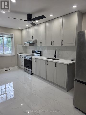 Brampton (Brampton West) apartment for rent - A modern kitchen with a stainless steel refrigerator and a ceiling fan.