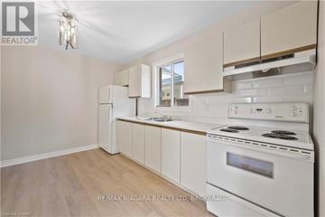 Niagara Falls (Dorchester) townhouse for rent - A kitchen with white appliances and wooden floors.