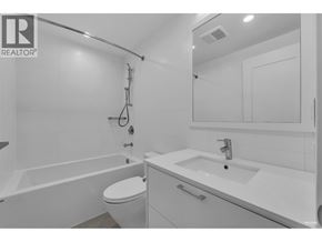 Burnaby apartment for rent - A white bathroom with a toilet, sink, and bathtub.
