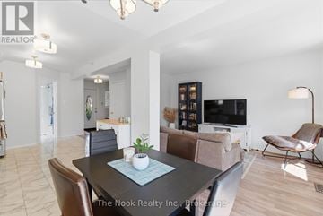 Oshawa (Pinecrest) apartment for rent - A living room with a black table and brown chairs.