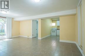 Toronto (Bedford Park-Nortown) apartment for rent - A spacious room with tile flooring and a kitchenette in the corner.