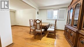 Toronto (Pleasant View) apartment for rent - A room with wooden floors and furniture including a wooden table and chairs.