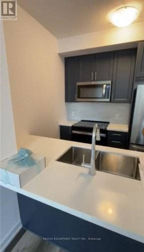 Hamilton (Waterdown) condo for rent - A kitchen with a sink and a microwave.