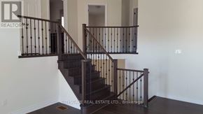 Niagara Falls (Brown) apartment for rent - A staircase with a metal railing and wooden steps.