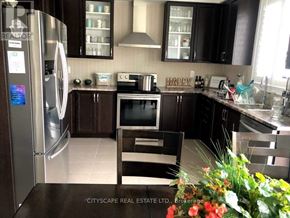 Niagara Falls (Brown) apartment for rent - A kitchen with a refrigerator, oven, and microwave.