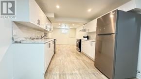 Toronto (Pleasant View) apartment for rent - A modern kitchen with a refrigerator on the right side.