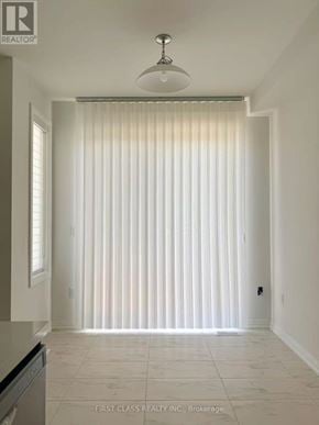 Richmond Hill townhouse for rent - A white room with a light on the ceiling and a window with blinds.