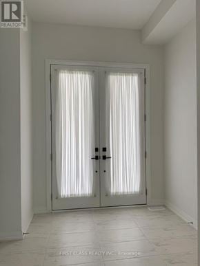 Richmond Hill townhouse for rent - A white door with a glass panel and a black handle.
