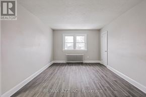 Oshawa (O'neill) multi-family for rent - A room with a window and a radiator on the floor.