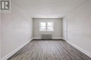 Oshawa (O'neill) multi-family for rent - A room with a window and a radiator on the floor.
