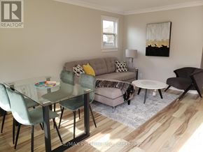 Oshawa (Centennial) apartment for rent - A modern living room with a glass table and chairs.