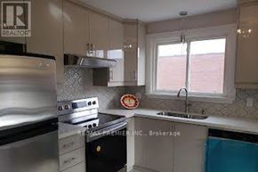 Oshawa (Centennial) apartment for rent - A kitchen with a stove top oven and a sink.