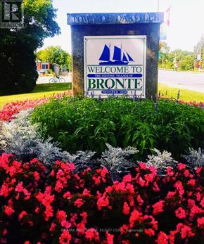 Oakville (Br Bronte) condo for rent - A sign welcoming people to Bronte surrounded by flowers.