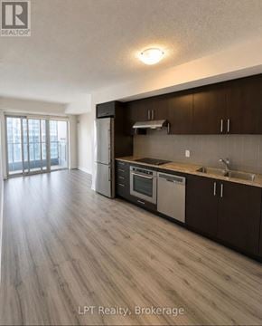 Toronto (Agincourt South-Malvern West) condo for rent - A kitchen with wooden cabinets and a stainless steel dishwasher.