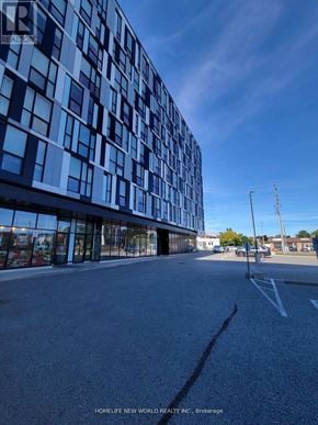 Oshawa (Samac) condo for rent - A modern building with a glass facade is the main focus of the image.