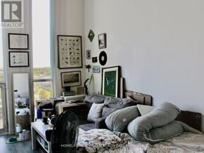 Oshawa (Samac) condo for rent - A bedroom with a bed, pillows, and pictures on the wall.