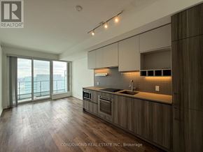 Vaughan (Concord) condo for rent - A modern kitchen with wooden cabinets and a large window.