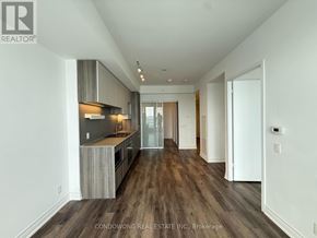 Vaughan (Concord) condo for rent - A spacious kitchen with wooden floors and white walls.