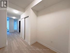 Toronto (Banbury-Don Mills) condo for rent - A room with a sliding door and wood flooring.