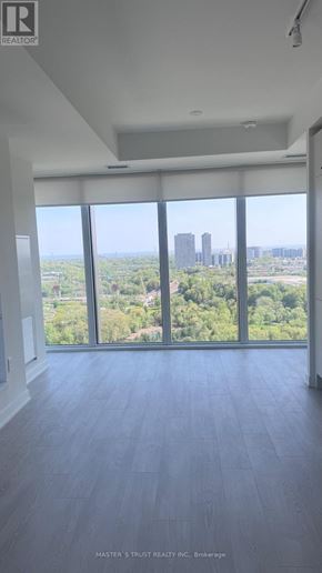 Toronto (Banbury-Don Mills) condo for rent - A room with a view of the cityscape through large windows.