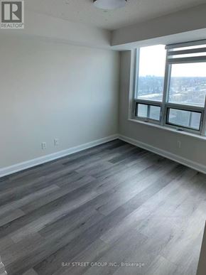 Toronto (Newtonbrook West) condo for rent - A room with a large window and wooden flooring.