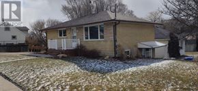Guelph (St. George's) apartment for rent - A house with a brown brick exterior and a white porch.