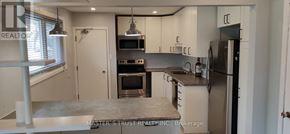 Guelph (St. George's) apartment for rent - A kitchen with a refrigerator, oven, and microwave.