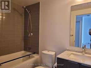 Toronto (Bay Street Corridor) condo for rent - A bathroom with a white toilet, sink, and a glass shower stall.