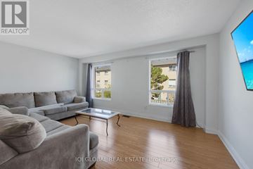 Brampton (Fletcher's Creek South) townhouse for rent - A living room with a grey couch and a coffee table.